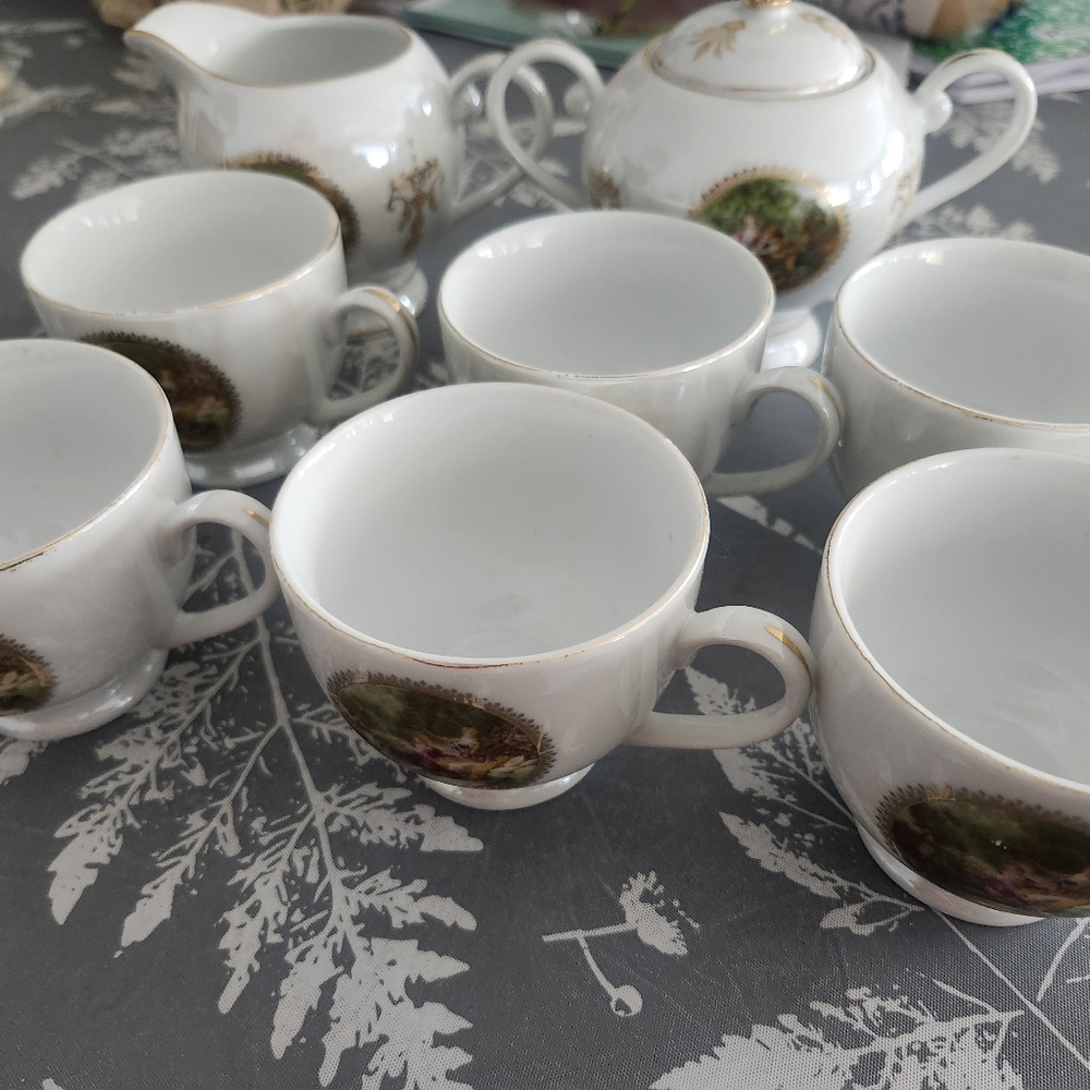 White Porcelain Tea Cup Set with Gold Trim and Scenic Medallions